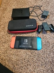 Nintendo Switch with Neon Blue and Neon Red Joy-Con and case