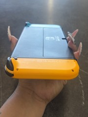 NINTENDO SWITCH OLED MODEL W/ NEON BLUE & NEON ORANGE JOY CONS