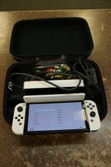 Nintendo Switch OLED HEG-001 64GB 1080p White Bundle Dock Joy-Cons Cases