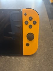 NINTENDO SWITCH OLED MODEL W/ NEON BLUE & NEON ORANGE JOY CONS